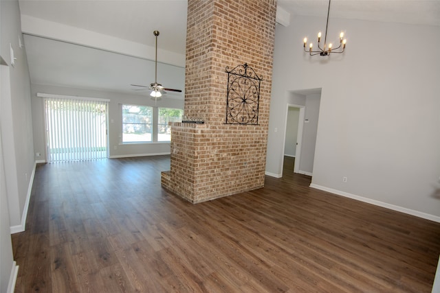 unfurnished living room with ceiling fan with notable chandelier, dark hardwood / wood-style floors, and high vaulted ceiling