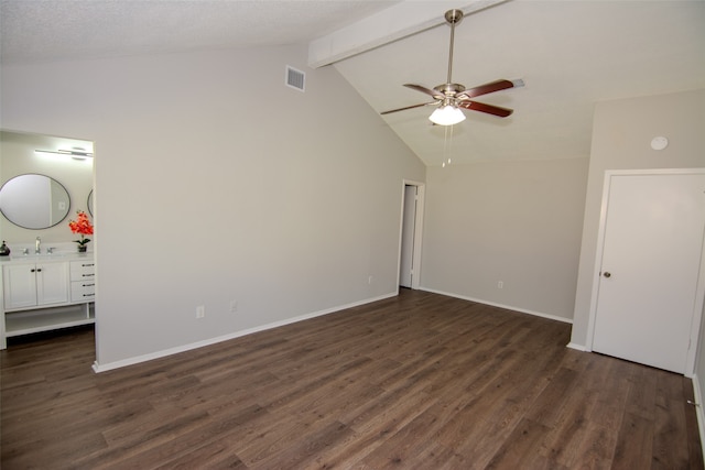 spare room with ceiling fan, sink, dark hardwood / wood-style flooring, and lofted ceiling with beams