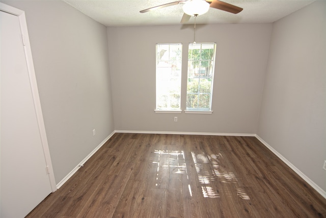 unfurnished room with a textured ceiling, ceiling fan, and dark hardwood / wood-style flooring