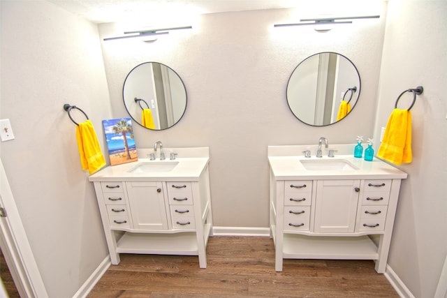 bathroom with hardwood / wood-style floors and vanity