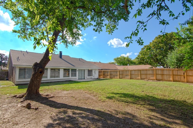 rear view of property with a lawn