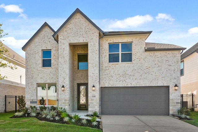 view of front of property with a front yard and a garage