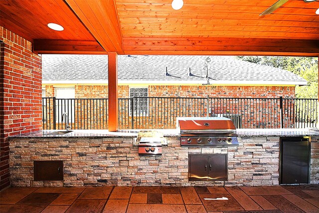 view of patio / terrace with a gazebo, grilling area, ceiling fan, and an outdoor kitchen