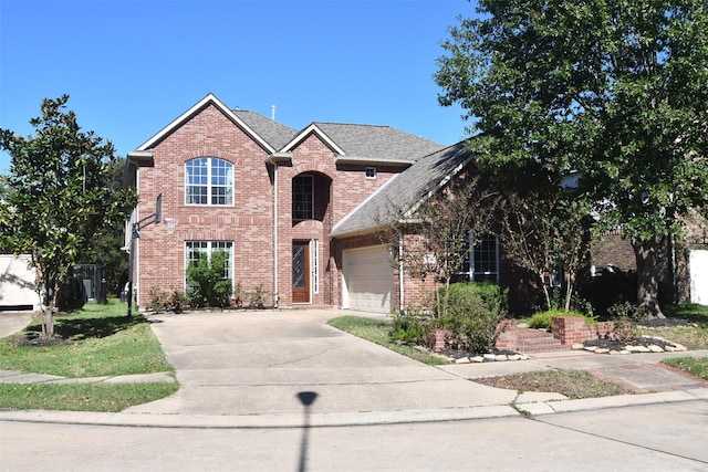 18526 W Laura Shore Dr, Cypress, TX 77433 - traditional-style house featuring a garage, concrete driveway, brick siding, and a shingled roof