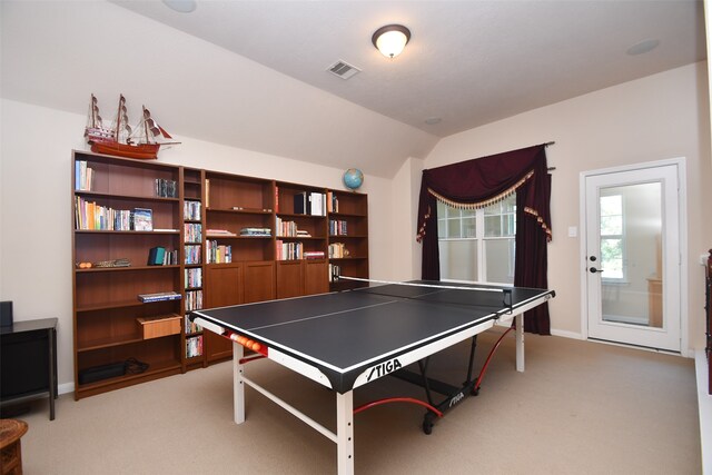 recreation room featuring light colored carpet and vaulted ceiling