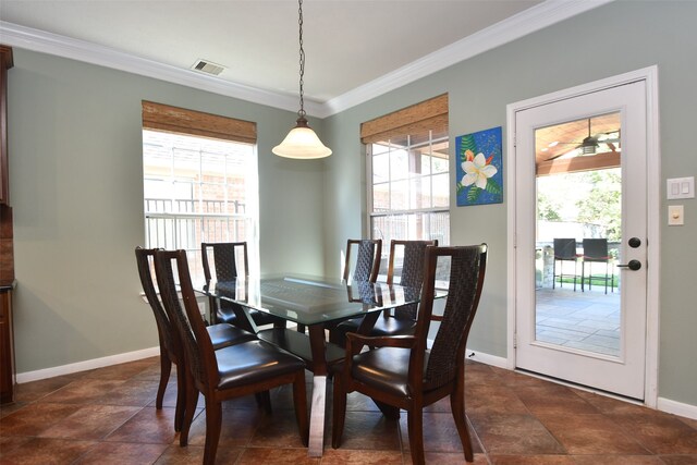 dining room with crown molding and plenty of natural light