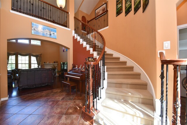 tiled foyer with a high ceiling