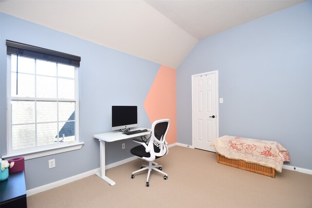 office space featuring carpet and vaulted ceiling