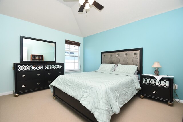 bedroom with vaulted ceiling, ceiling fan, and light colored carpet