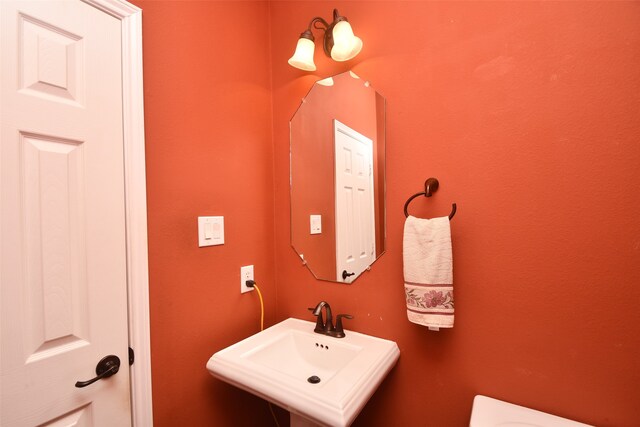 bathroom with sink and an inviting chandelier