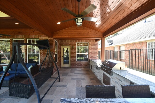 view of patio with ceiling fan, grilling area, and exterior kitchen