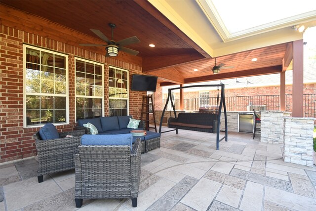 view of patio / terrace featuring an outdoor living space, an outdoor kitchen, and ceiling fan