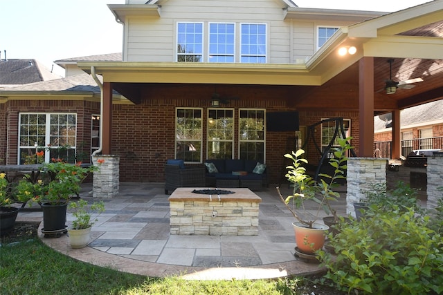 18526 W Laura Shore Dr, Cypress, TX 77433 - back of property featuring an outdoor living space with a fire pit, ceiling fan, a patio area, and brick siding