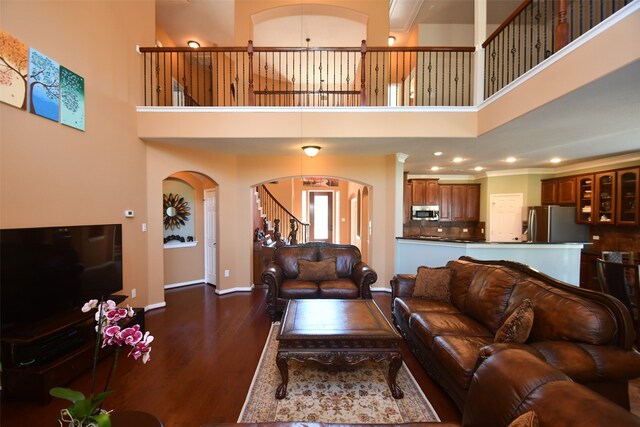 living room with a high ceiling and wood-type flooring