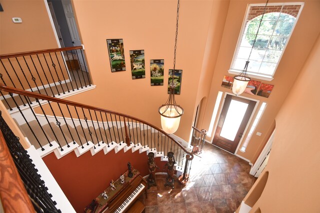 entryway featuring a towering ceiling