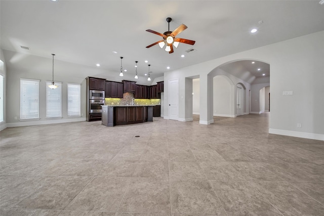 unfurnished living room featuring ceiling fan, sink, and light tile patterned floors