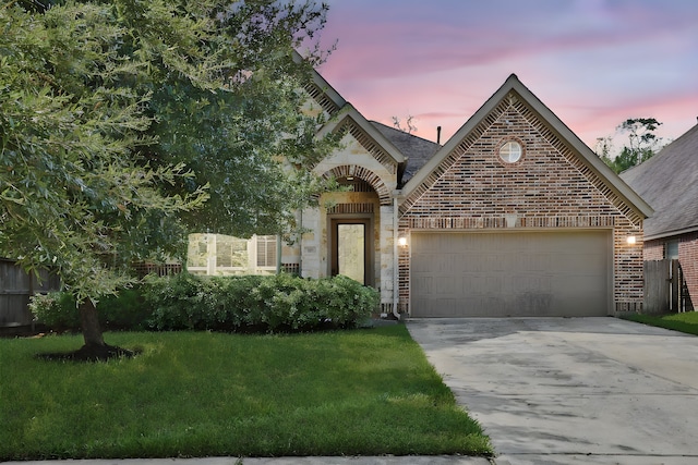 view of front facade with a lawn and a garage