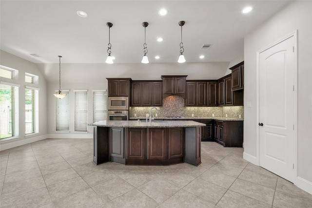 kitchen with dark brown cabinets, decorative light fixtures, backsplash, stainless steel appliances, and light stone counters