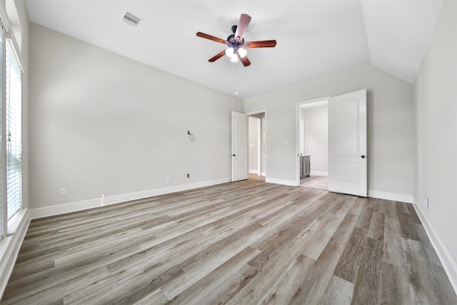 unfurnished bedroom with vaulted ceiling, light hardwood / wood-style flooring, and ceiling fan