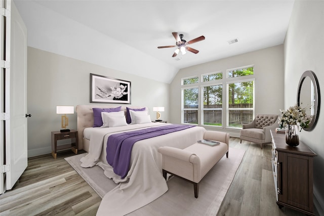 bedroom with light hardwood / wood-style flooring, ceiling fan, and lofted ceiling