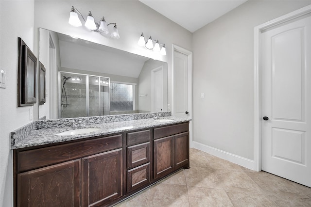 bathroom featuring tile patterned floors, vanity, vaulted ceiling, and a shower with door