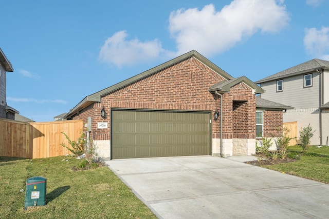 view of property featuring a garage and a front lawn