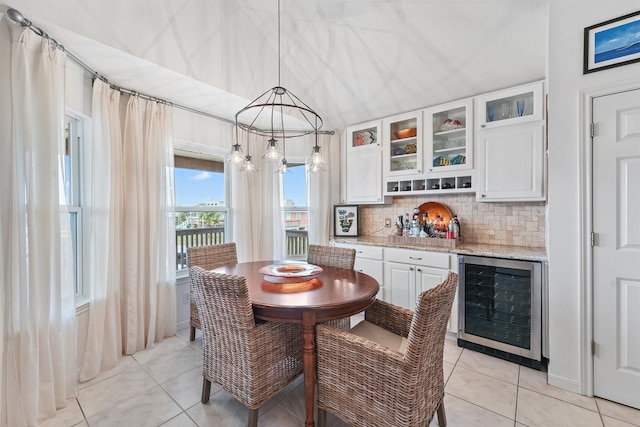 tiled dining space with bar and beverage cooler