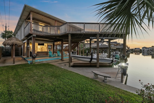 exterior space with a patio area, a water view, and a yard