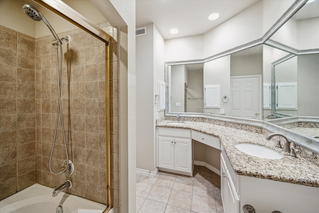 bathroom with tile patterned flooring, vanity, and tiled shower / bath combo