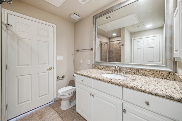 bathroom with tile patterned flooring, a shower with door, vanity, and toilet