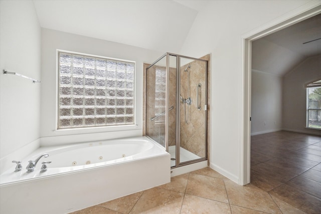 bathroom featuring tile patterned flooring, shower with separate bathtub, and vaulted ceiling