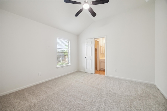 carpeted spare room featuring ceiling fan and lofted ceiling