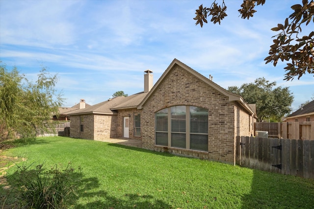 back of house with a lawn