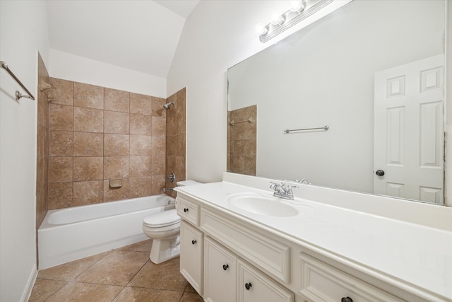 full bathroom with vanity, vaulted ceiling, tile patterned flooring, tiled shower / bath combo, and toilet