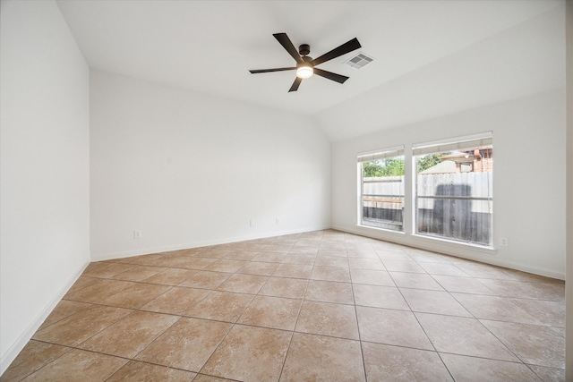 empty room featuring vaulted ceiling, ceiling fan, and light tile patterned flooring