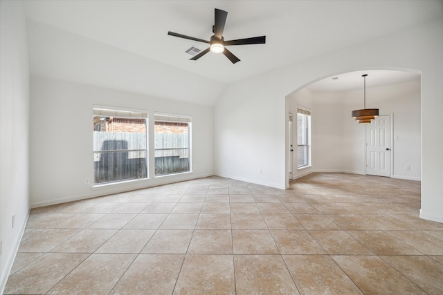 empty room with ceiling fan, light tile patterned flooring, and vaulted ceiling