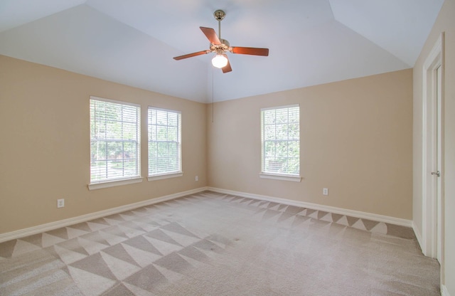 unfurnished room with vaulted ceiling, ceiling fan, a healthy amount of sunlight, and light carpet