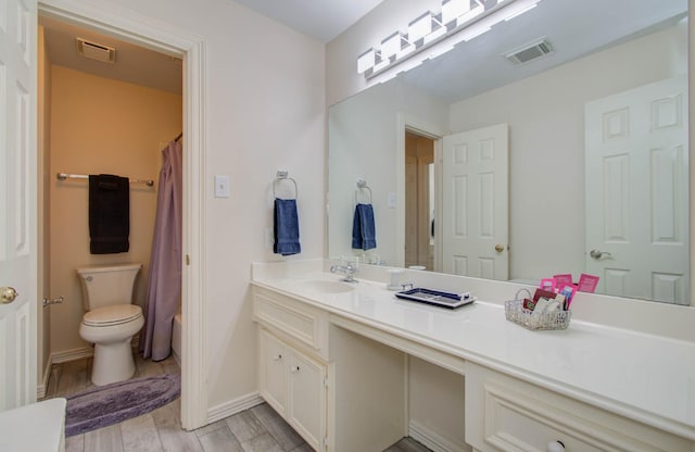 full bathroom featuring toilet, shower / bath combination with curtain, and vanity