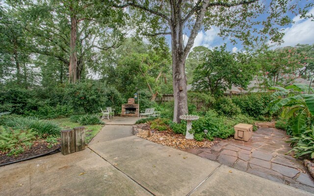 view of patio / terrace featuring an outdoor stone fireplace