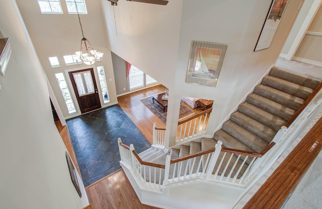 entryway featuring a wealth of natural light, dark hardwood / wood-style flooring, a high ceiling, and a notable chandelier