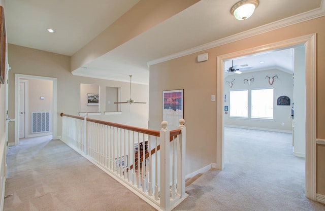 corridor with lofted ceiling, light colored carpet, and ornamental molding