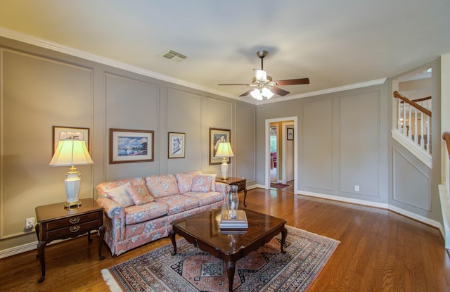 living room with ceiling fan, crown molding, and hardwood / wood-style flooring