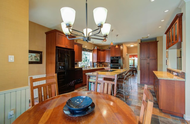 dining area featuring an inviting chandelier and sink