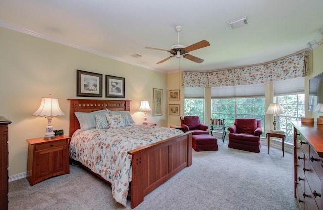 carpeted bedroom with ceiling fan, multiple windows, and ornamental molding