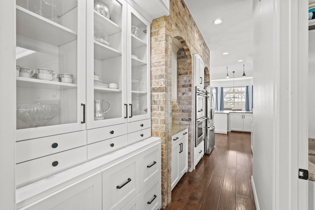 bar featuring white cabinetry and dark wood-type flooring