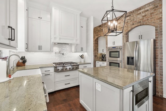 kitchen with white cabinetry, sink, stainless steel appliances, and pendant lighting