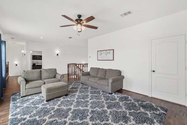 living room featuring dark hardwood / wood-style flooring and ceiling fan