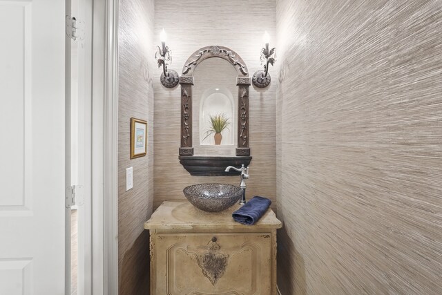 bathroom featuring vanity and tile walls