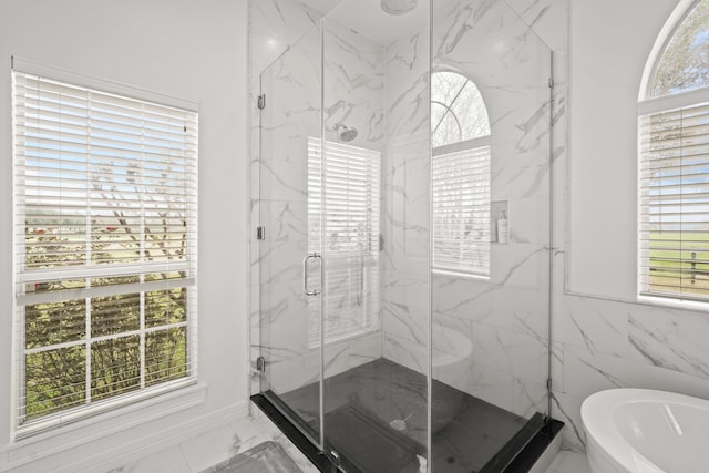 bathroom featuring separate shower and tub and tile walls