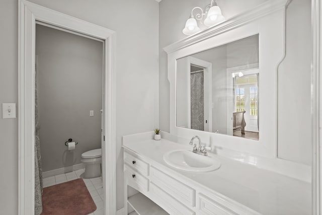 bathroom featuring tile patterned floors, vanity, and toilet